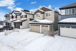 View of front of house featuring a residential view and an attached garage - 