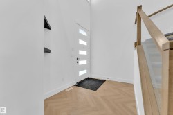 Foyer entrance featuring stairs and parquet flooring - 