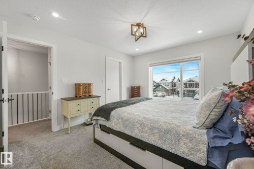 Bedroom with light colored carpet, a textured ceiling, and recessed lighting - 21 Sienna Boulevard, Fort Saskatchewan, AB - Indoor Photo Showing Bedroom