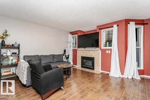 3 20 Deerbourne Drive, St. Albert, AB - Indoor Photo Showing Living Room With Fireplace