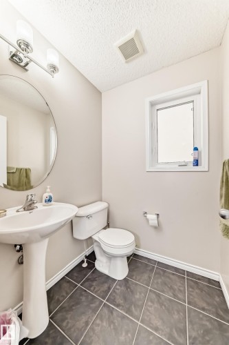 Bathroom with dark tile patterned floors and a textured ceiling - 5814 165 Avenue, Edmonton, AB - Indoor Photo Showing Bathroom