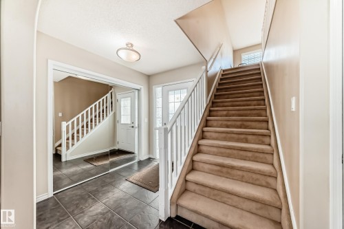 Stairs with baseboards and tile patterned flooring - 5814 165 Avenue, Edmonton, AB - Indoor Photo Showing Other Room