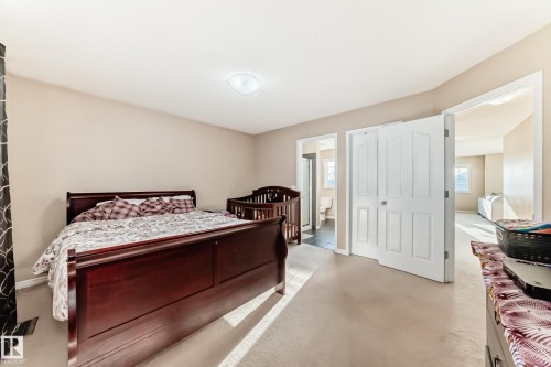 Carpeted bedroom featuring ensuite bathroom and baseboards - 5814 165 Avenue, Edmonton, AB - Indoor Photo Showing Bedroom