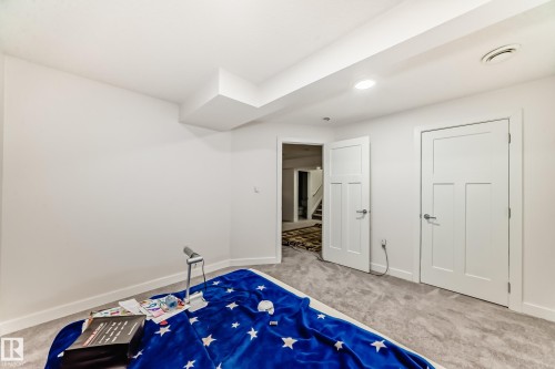 Unfurnished bedroom with carpet flooring - 5814 165 Avenue, Edmonton, AB - Indoor Photo Showing Bedroom