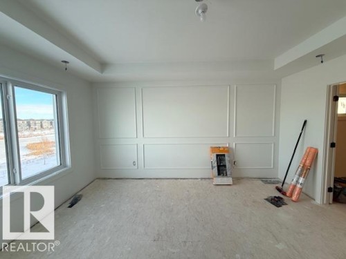 Unfurnished room with plenty of natural light, a decorative wall, and a tray ceiling - 16512 34 Avenue, Edmonton, AB - Indoor Photo Showing Other Room