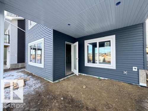 View of property exterior with a patio - 16512 34 Avenue, Edmonton, AB - Outdoor With Deck Patio Veranda With Exterior