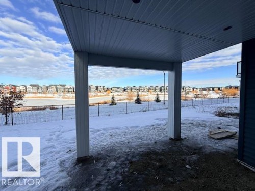 Yard layered in snow featuring a residential view and a patio area - 16512 34 Avenue, Edmonton, AB - Outdoor With View