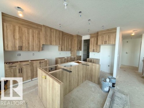 Kitchen featuring a kitchen island and a textured ceiling - 16512 34 Avenue, Edmonton, AB - Indoor Photo Showing Kitchen