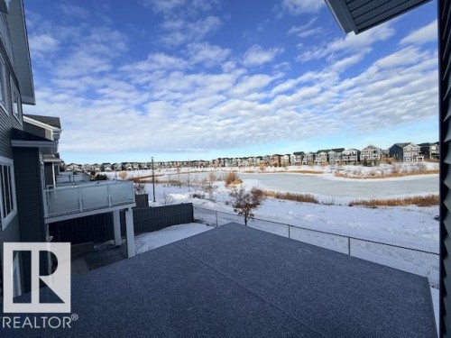 Snow covered patio with a patio area and a residential view - 16512 34 Avenue, Edmonton, AB - Outdoor With View