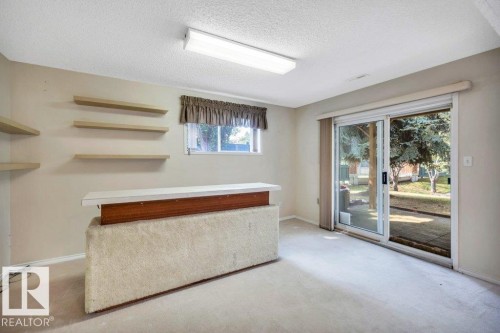 Bar area featuring light colored carpet, a textured ceiling, and light countertops - 112 Haddow Close, Edmonton, AB - Indoor Photo Showing Other Room