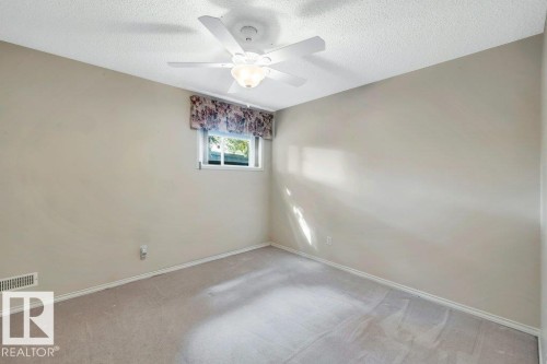Carpeted empty room with a textured ceiling and a ceiling fan - 112 Haddow Close, Edmonton, AB - Indoor Photo Showing Other Room
