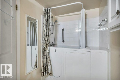 Full bath with shower / tub combo with curtain and washer / dryer - 112 Haddow Close, Edmonton, AB - Indoor Photo Showing Bathroom