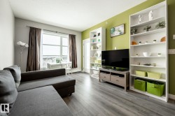 Living area with light wood-type flooring and a baseboard radiator - 