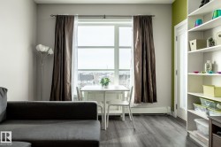 Living area with a baseboard radiator and dark wood-style floors - 