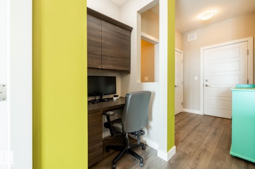 Office featuring dark wood finished floors and built in study area - 407 2590 Anderson Way, Edmonton, AB - Indoor