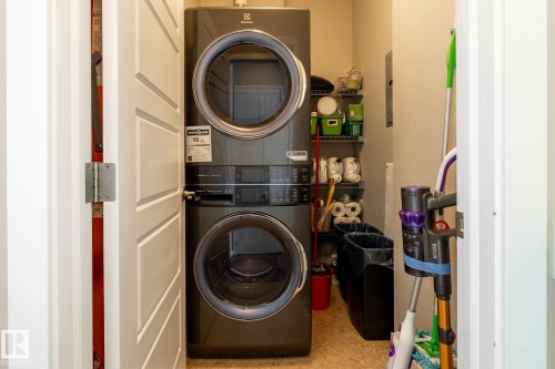Laundry room with stacked washer / drying machine - 407 2590 Anderson Way, Edmonton, AB - Indoor Photo Showing Laundry Room