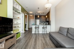 Living room with light wood-style floors and a textured ceiling - 