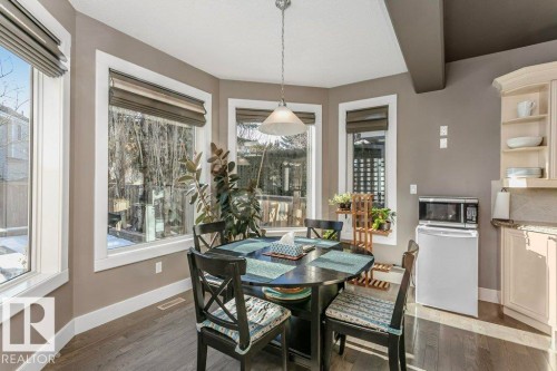 Dining room with dark wood-style floors and beam ceiling - 1579 Hector Road, Edmonton, AB - Indoor Photo Showing Dining Room
