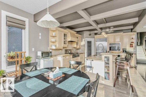 Dining space with light wood-type flooring and coffered ceiling - 1579 Hector Road, Edmonton, AB - Indoor