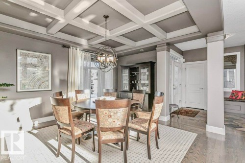 Dining area featuring coffered ceiling, wood finished floors, and decorative columns - 1579 Hector Road, Edmonton, AB - Indoor Photo Showing Dining Room