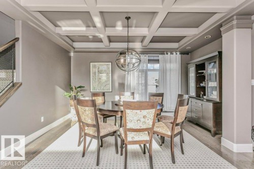 Dining space with coffered ceiling, wood finished floors, and suspended lighting - 1579 Hector Road, Edmonton, AB - Indoor Photo Showing Dining Room