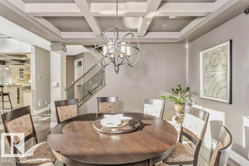 Dining area featuring coffered ceiling, wood finished floors, suspended lighting, and ornate columns - 1579 Hector Road, Edmonton, AB - Indoor Photo Showing Dining Room