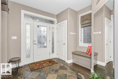 Foyer with dark wood finished floors and a textured ceiling - 1579 Hector Road, Edmonton, AB - Indoor Photo Showing Other Room