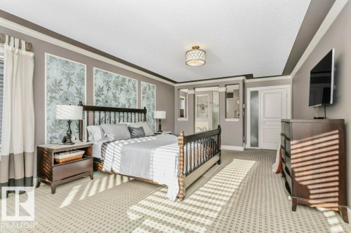 Bedroom with crown molding, carpet, and a textured ceiling - 1579 Hector Road, Edmonton, AB - Indoor Photo Showing Bedroom