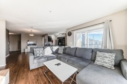 Living area with dark wood-style floors and baseboards - 