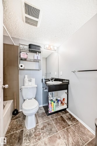 Full bathroom featuring a textured ceiling, vanity, and bathtub / shower combination - 302 530 Watt Boulevard Sw, Edmonton, AB - Indoor Photo Showing Bathroom