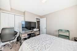 Carpeted bedroom with a closet and a desk - 