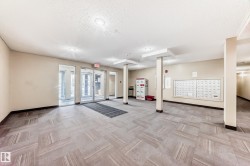 Community lobby featuring a textured ceiling - 
