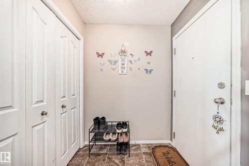 Entryway featuring a textured ceiling and baseboards - 302 530 Watt Boulevard Sw, Edmonton, AB - Indoor Photo Showing Other Room