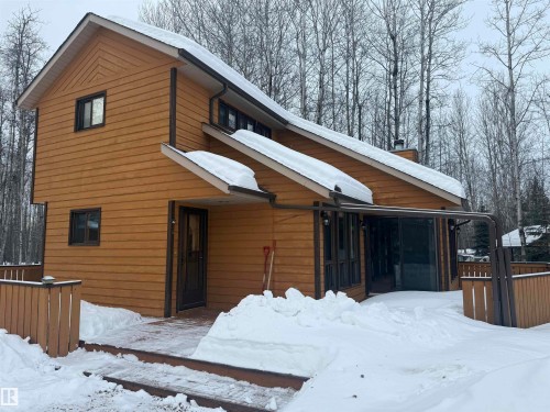 Snow covered rear of property featuring a chimney - 34 Ella Mae Crescent, Rural Athabasca County, AB - Outdoor With Exterior