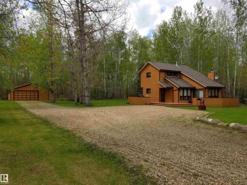View of front of property with a deck, a front lawn, a detached garage, an outbuilding, and driveway - 34 Ella Mae Crescent, Rural Athabasca County, AB - Outdoor