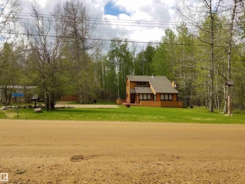 View of front of property with a front yard, a chimney, and roof with shingles - 34 Ella Mae Crescent, Rural Athabasca County, AB - Outdoor