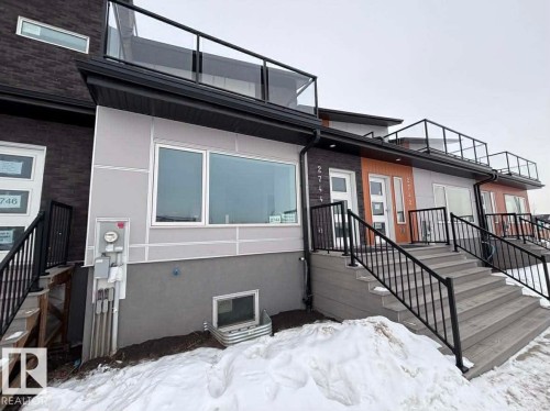 Snow covered rear of property with stucco siding - 2744 Blatchford Road, Edmonton, AB - Outdoor With Exterior