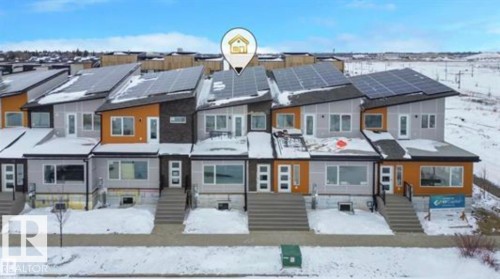 Snow covered back of property featuring solar panels - 2744 Blatchford Road, Edmonton, AB - Outdoor With Facade