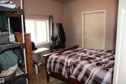 Bedroom with dark tile patterned flooring - 
