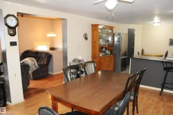 Dining room featuring light wood-style flooring and hanging lights - 