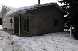 View of snow covered exterior with a patio area - 