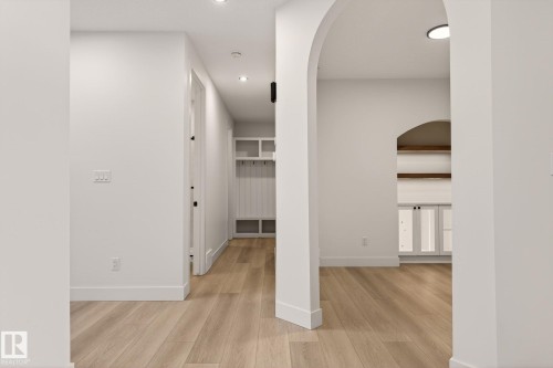 Hall with arched walkways, light wood-type flooring, and recessed lighting - 9 Elwyck Gate, Spruce Grove, AB - Indoor Photo Showing Other Room