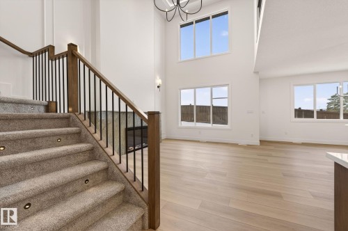 Entrance foyer featuring light wood finished floors, a high ceiling, and hanging lights - 9 Elwyck Gate, Spruce Grove, AB - Indoor Photo Showing Other Room