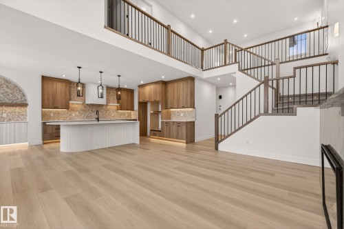 Unfurnished living room with recessed lighting, light wood-style floors, and a high ceiling - 9 Elwyck Gate, Spruce Grove, AB - Indoor Photo Showing Kitchen With Upgraded Kitchen