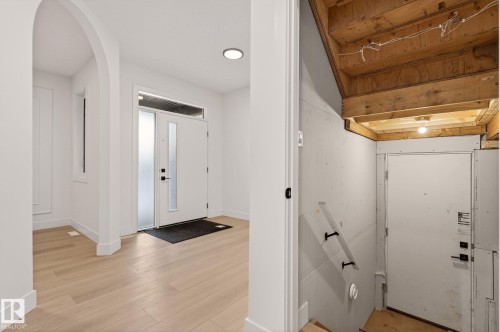 Foyer entrance featuring arched walkways and light wood-style floors - 9 Elwyck Gate, Spruce Grove, AB - Indoor