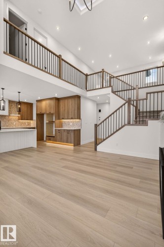 Unfurnished living room with recessed lighting, a high ceiling, and light wood-style flooring - 9 Elwyck Gate, Spruce Grove, AB - Indoor Photo Showing Other Room