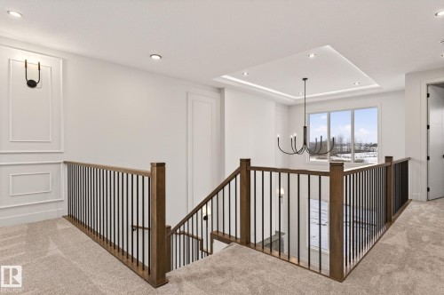 Corridor featuring carpet, hanging lights, a tray ceiling, and an upstairs landing - 9 Elwyck Gate, Spruce Grove, AB - Indoor Photo Showing Other Room