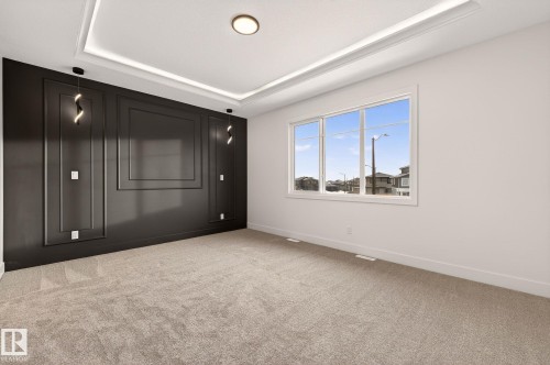 Unfurnished bedroom with light colored carpet and a raised ceiling - 9 Elwyck Gate, Spruce Grove, AB - Indoor Photo Showing Other Room