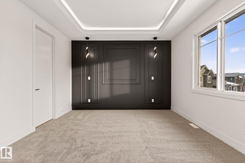 Empty room featuring a tray ceiling and light colored carpet - 9 Elwyck Gate, Spruce Grove, AB - Indoor Photo Showing Other Room