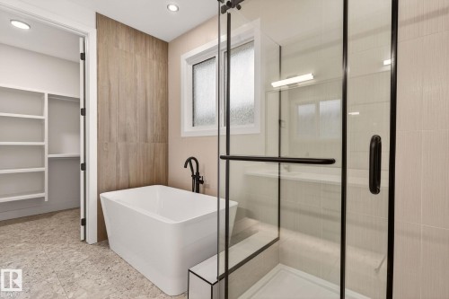 Bathroom with a freestanding tub, a shower stall, a spacious closet, and recessed lighting - 9 Elwyck Gate, Spruce Grove, AB - Indoor Photo Showing Bathroom